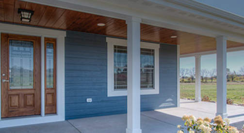 Home design with wrap around prairie porch with stunning entrance in Whitewater