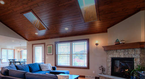 Cathedral wood ceiling with skylights and cozy fireplace for Lake Geneva home